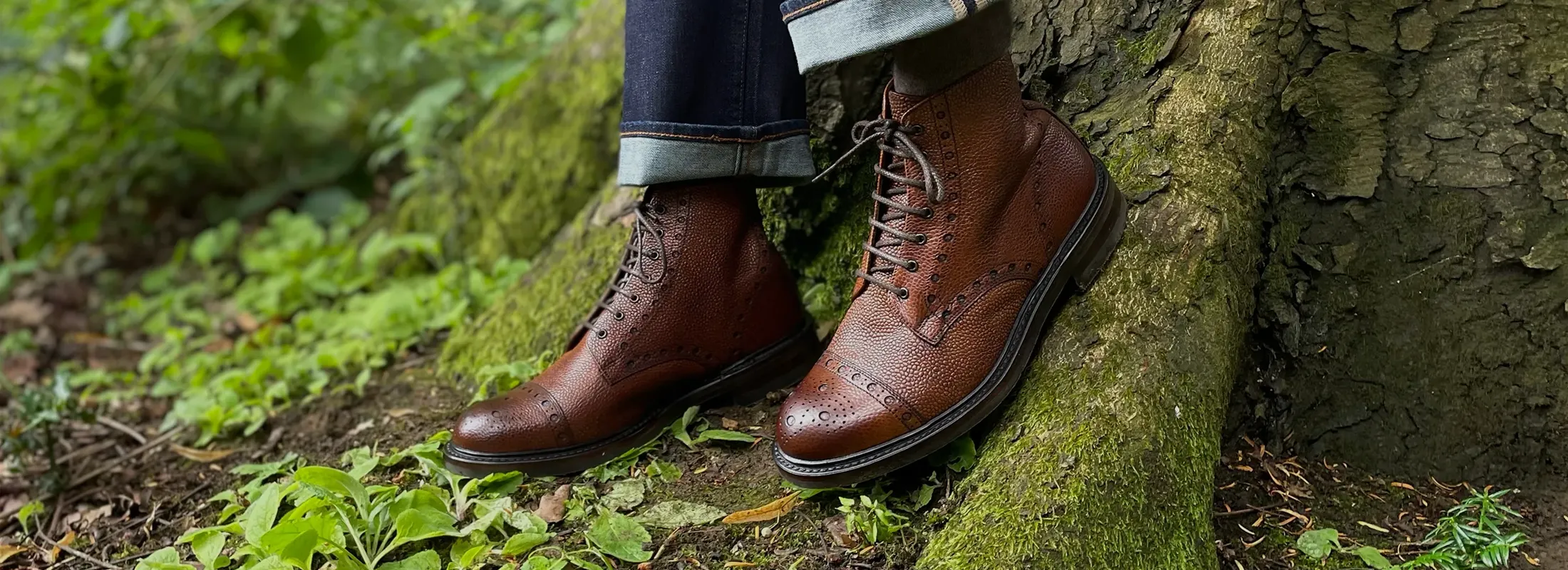 Man walking in forest, wearing his Loake Seasonal Winter Boots. Shoes shown are Loxley in Brown Grain leather