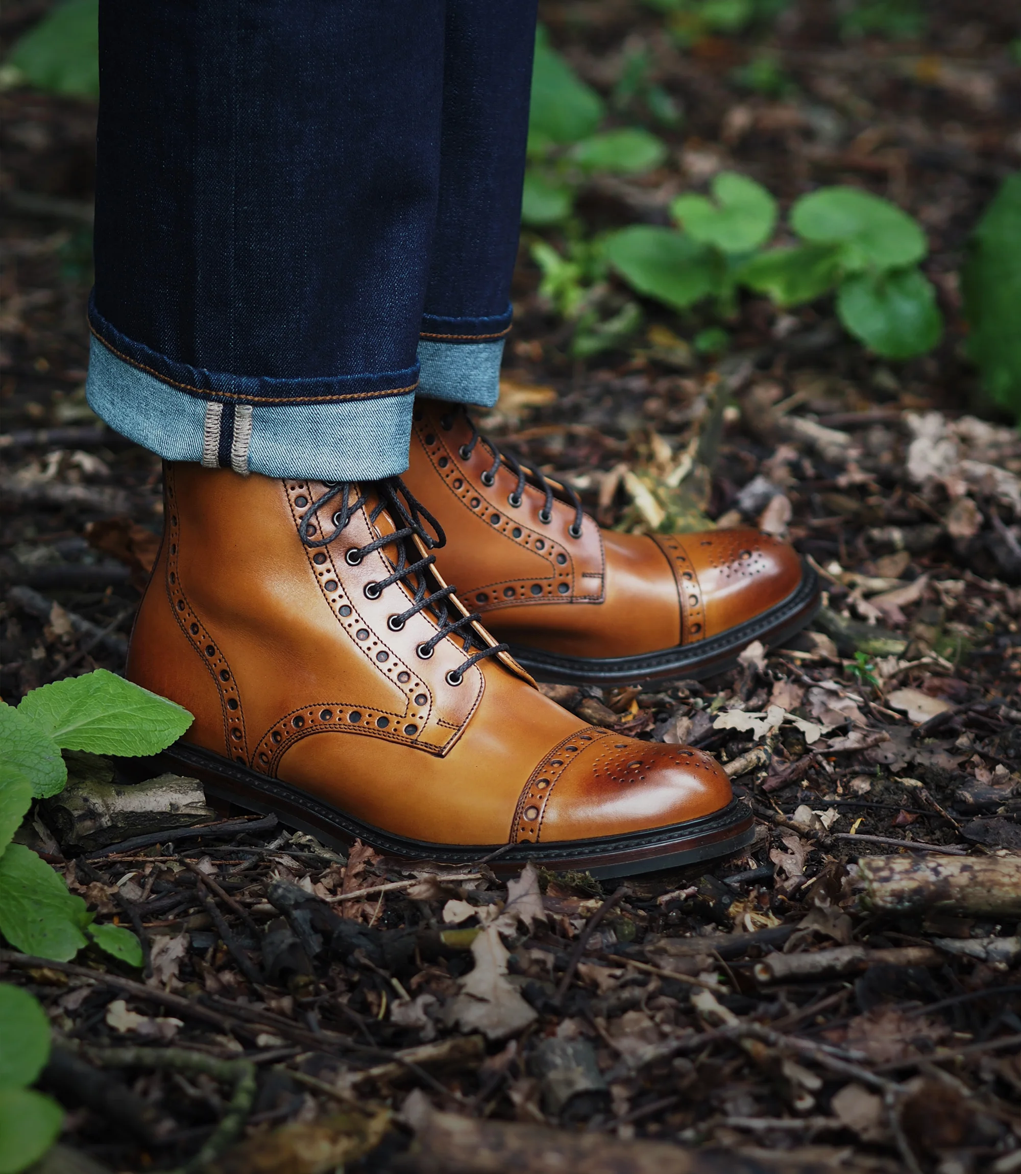 Man wearing his english made Loake Loxley Derby Boots in Tan Calf leather, whilst walking in a wooded area